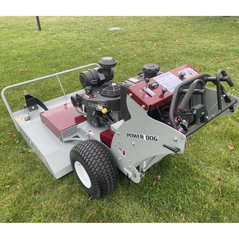 Grazer Brush Mower 24 HP Kawasaki in gray and burgundy, angled view with large wheels and controls.