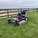 Grazer Brush Mower 24 HP Kawasaki in red and gray, angled view with large wheels and engine.