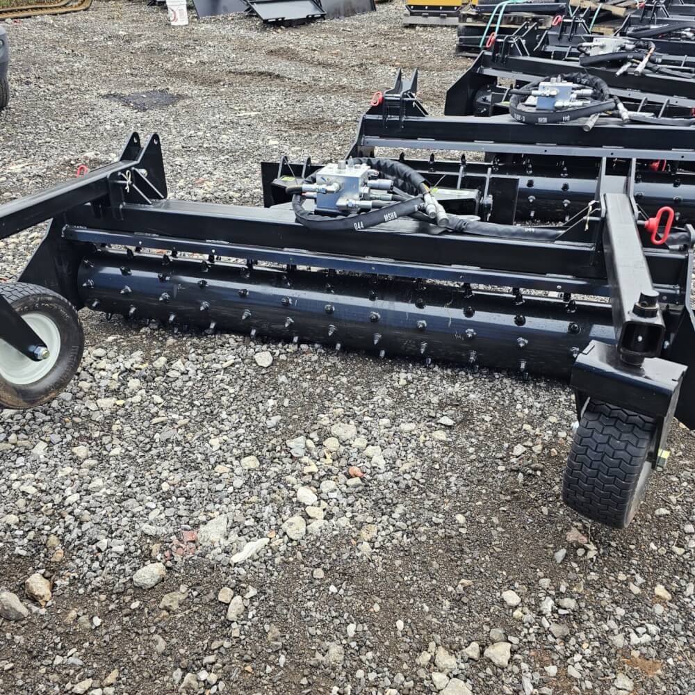 HD Soil Conditioner by Prime Attachments, angled view, black with wheels and tines.