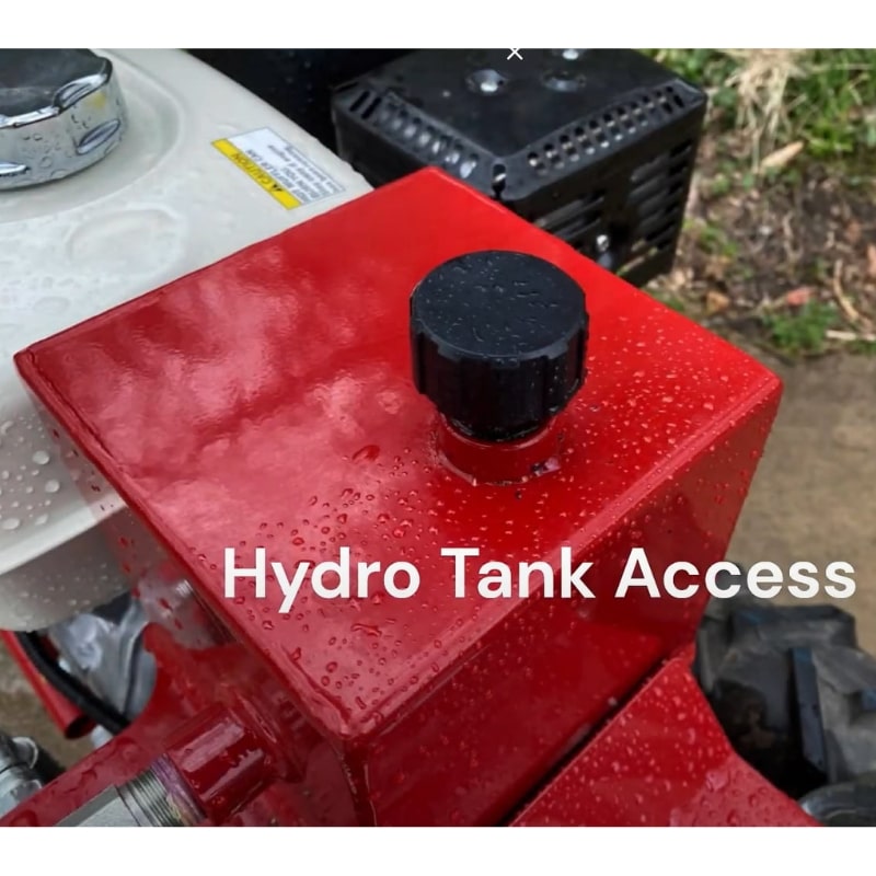 Power Dog 209 hydro tank access close-up, hydraulic system fill point with red tank