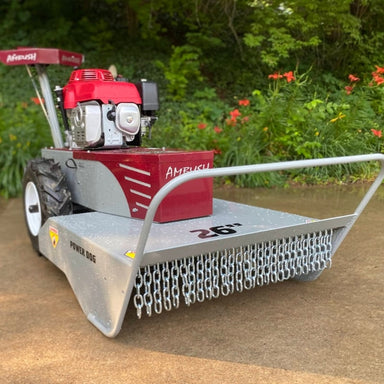 Side angle view of 26-inch Ambush walk-behind brush mower showing cutting deck and chain guard