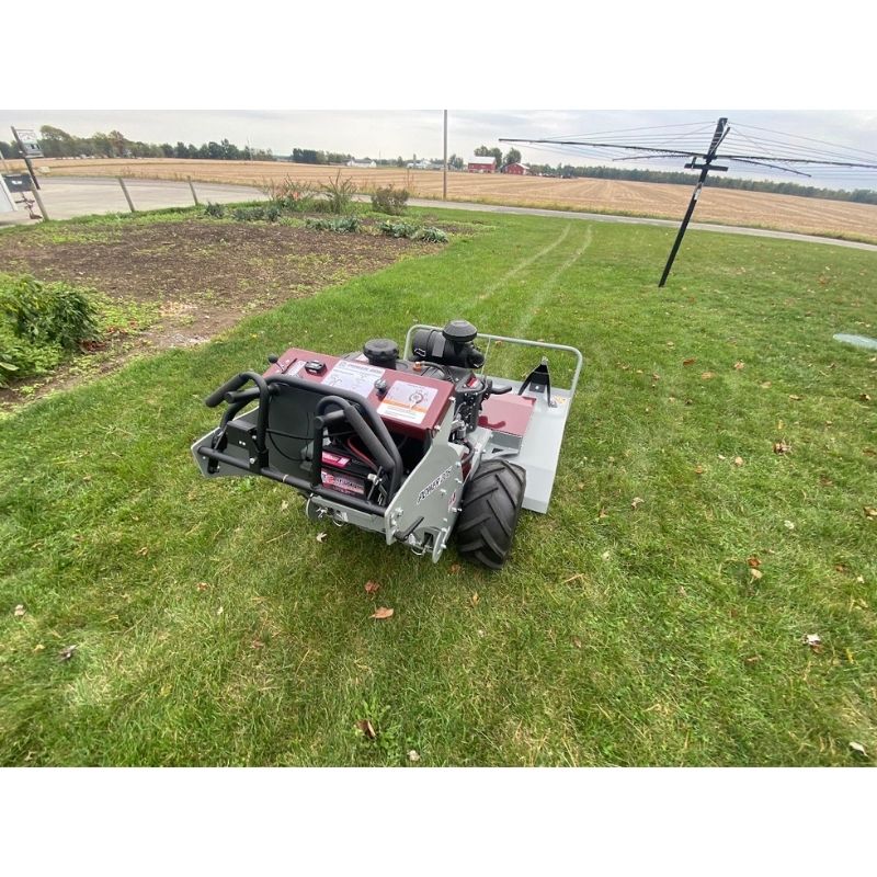 Power Dog brush mower rear view on grassy lawn.