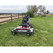 Power Dog brush mower front view on open field.