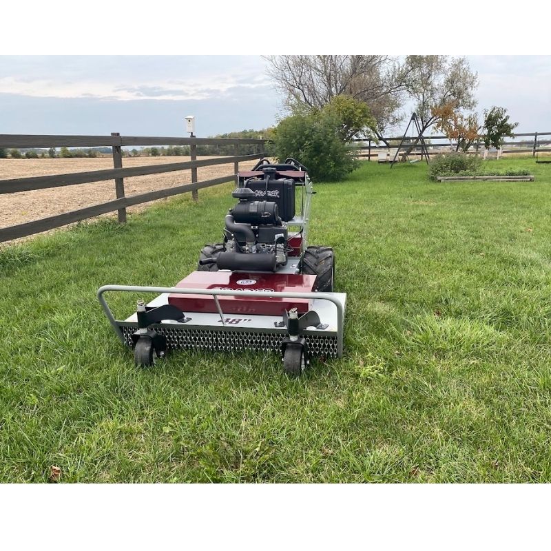 Power Dog brush mower front view on open field.