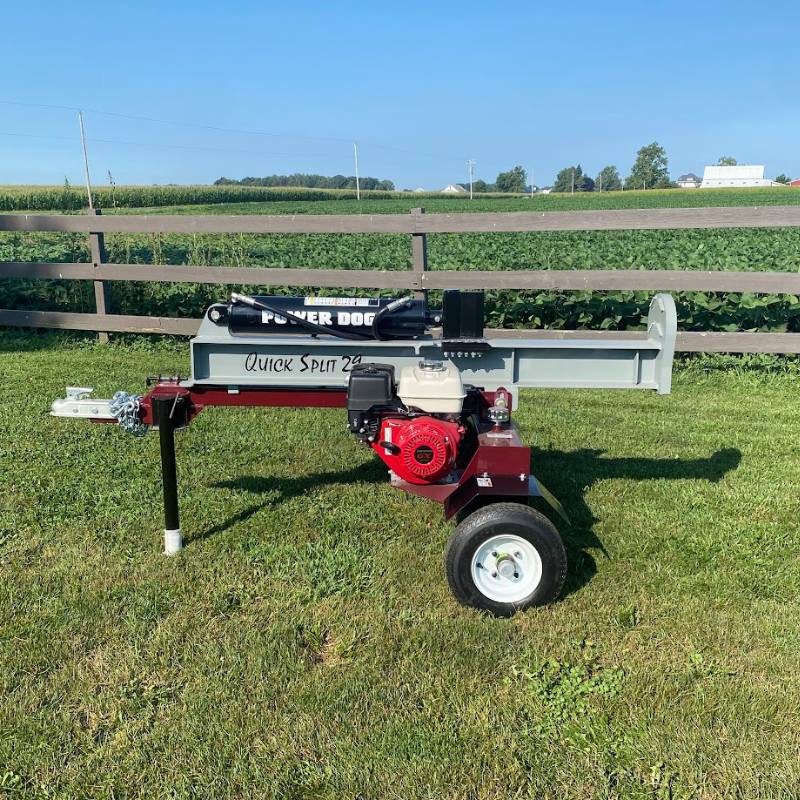 Power Dog Quick Split log splitter side view on open field.