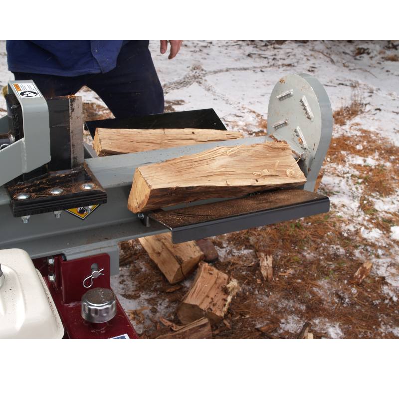 Power Dog Quick Split log splitter splitting firewood, close-up of beam, wedge, and logs during operation.