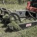 Prime Attachments Skid Steer Mower Attachment, angled view, black with dual blades and warning label.