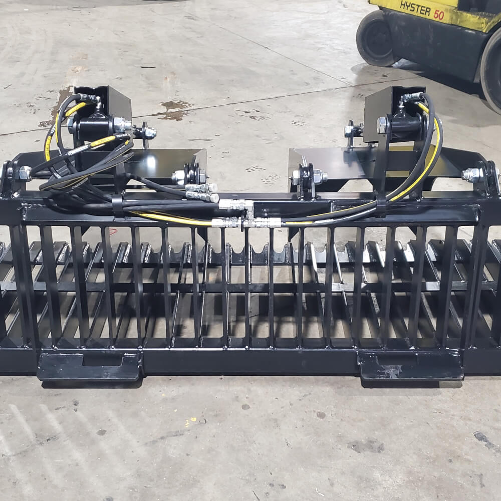 Rock and Brush Grapple Glacier Attachments front view, black with hydraulic hoses and sturdy grating.