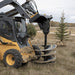Skid Steer Auger Drive by Prime Attachments, black with triple blades, angled view in operation.