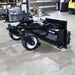 Skid Steer Soil Conditioner by Glacier Attachments, black with wheels and angled view.