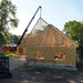 Skid Steer Teleboom by Prime Attachments, black, angled view with extended boom for construction.