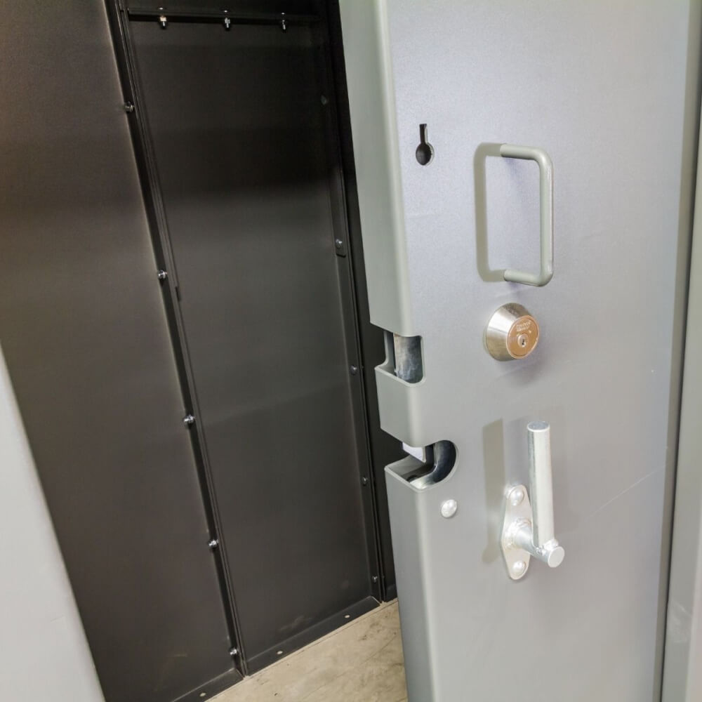 Swisher 20 Person ESP Safety Shelter front view, gray with secure locking mechanism and handle.