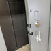Swisher 20 Person ESP Safety Shelter front view, gray with secure locking mechanism and handle.