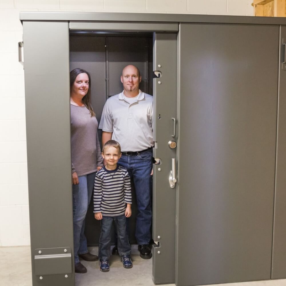 Swisher 20 Person ESP Safety Shelter, gray, front view, secure door, spacious interior.