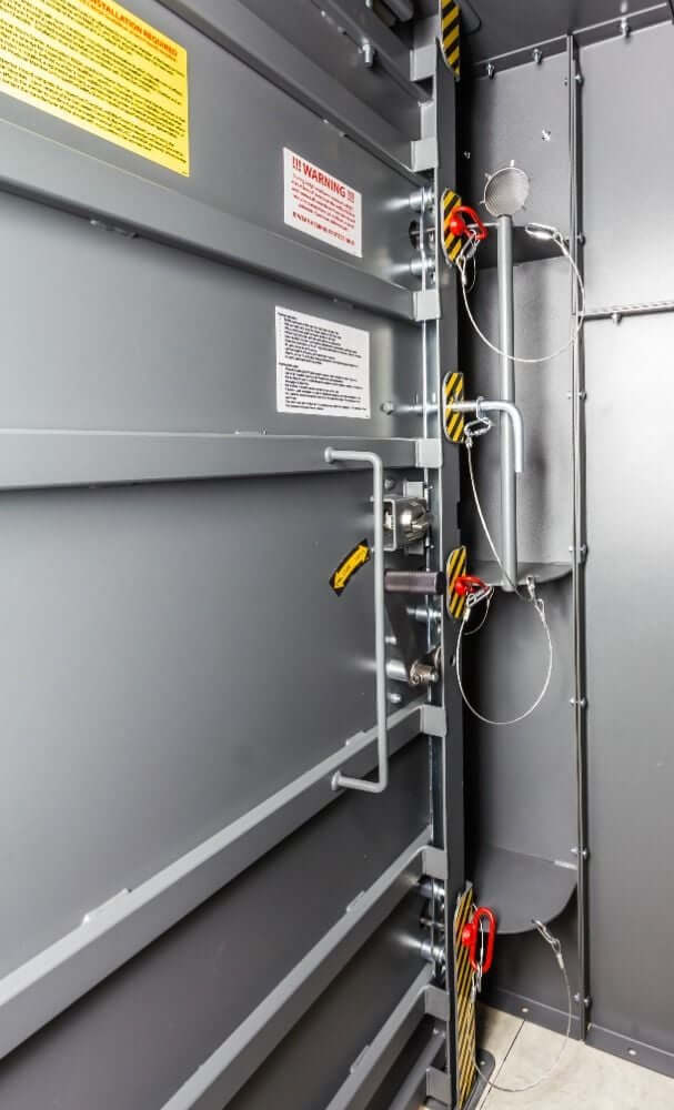 Swisher 20 Person ESP Safety Shelter interior view, gray panels with safety features and warning labels.