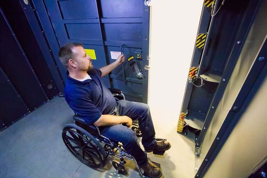 Swisher 20 Person ESP Wheelchair Accessible Storm Shelter, interior view with accessible features and secure door.