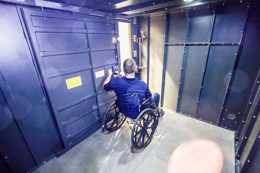 Swisher 20 Person ESP Wheelchair Accessible Storm Shelter, front view with sturdy metal walls and door.