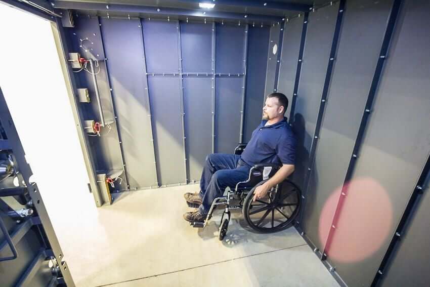 Swisher 20 Person ESP Wheelchair Accessible Storm Shelter interior view, gray metal walls, accommodates wheelchair.