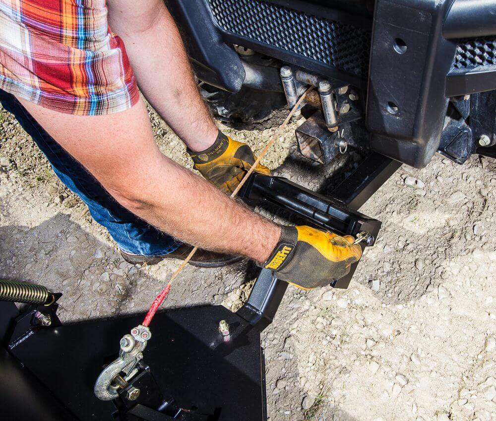 Swisher 2850 62" UTV Plow Blade attachment, black, showing mounting mechanism and rope.
