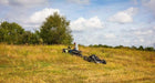 Swisher 44 Commercial Pro Rough Cut Mower, angled view, black, featuring large wheels and durable cutting deck.