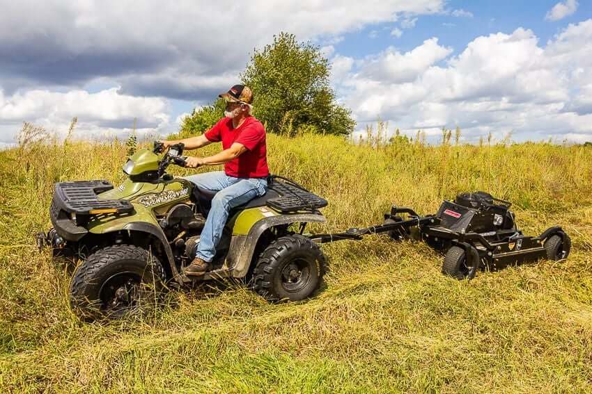 Swisher 44 Commercial Pro Rough Cut Mower, black, angled view, attached to an ATV.
