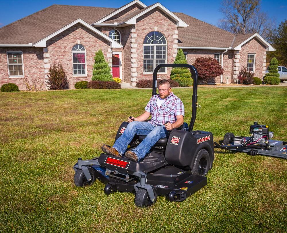 Swisher 44 Finish Cut Mower, black, with a rider seat and large cutting deck.