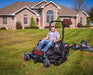 Swisher 44 Finish Cut Mower, black, with a rider seat and large cutting deck.