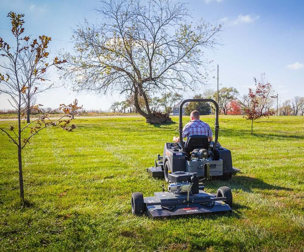 Swisher 44 Finish Cut Mower, black and gray, rear view with large wheels and mower deck.