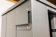 Swisher 6 Person ESP Safety Shelter angled view, grey color with metal hardware details.