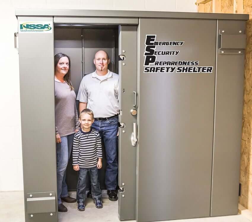Swisher 6 Person ESP Safety Shelter front view, gray metal construction with a secure locking mechanism.
