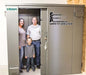 Swisher 6 Person ESP Safety Shelter front view, gray metal construction with a secure locking mechanism.