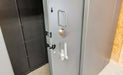 Swisher 6 Person ESP Safety Shelter, gray door with secure locking mechanism and handle.