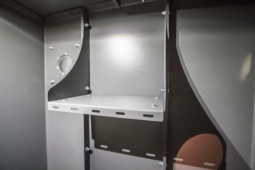 Swisher 6 Person ESP Safety Shelter interior view, gray metal with shelf and mounting brackets.