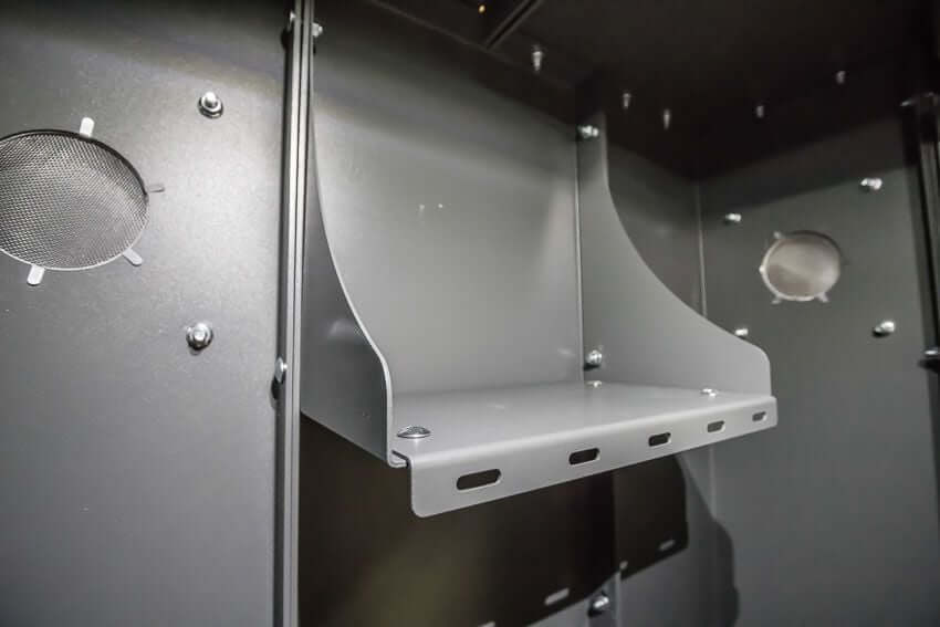 Swisher 6 Person ESP Safety Shelter internal view with gray metal shelves and ventilation openings.