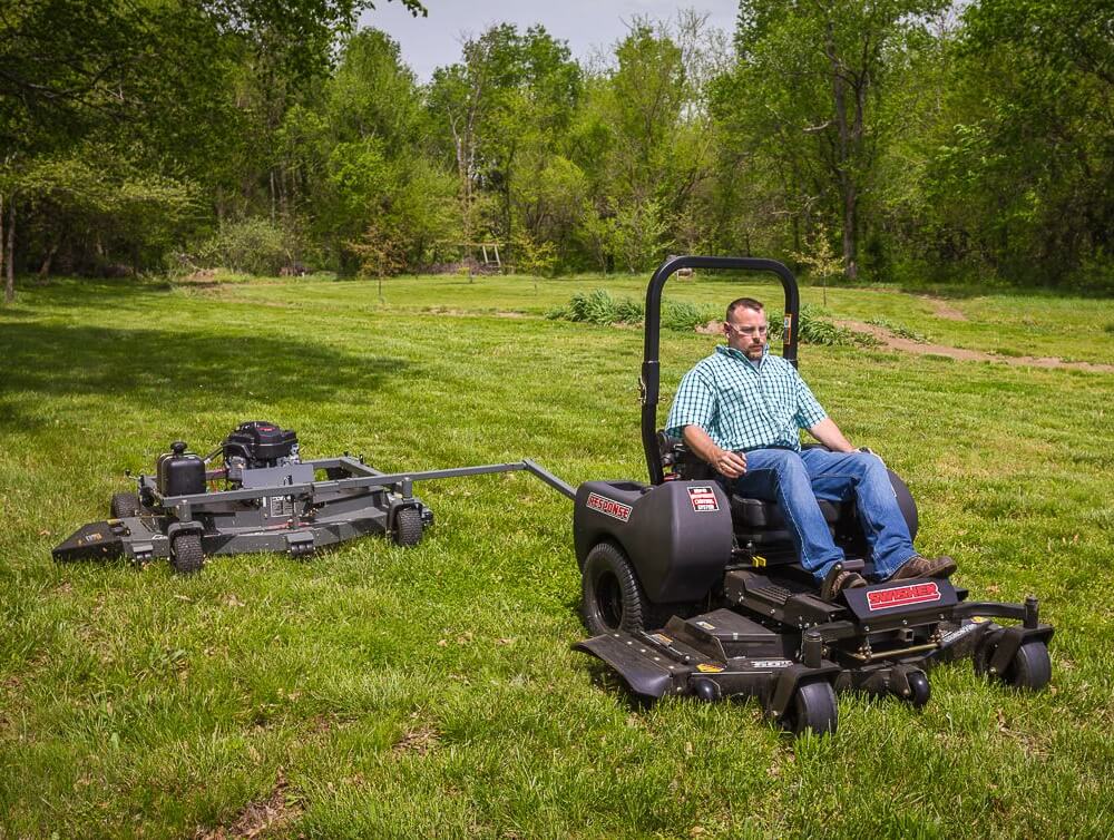 Swisher 66 Commercial Mower, 14.5HP Kawasaki, black with handlebars and multiple cutting decks.