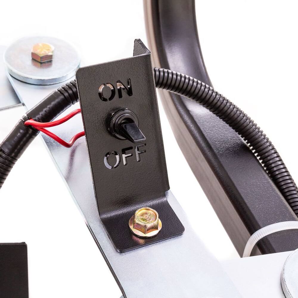 Swisher Commercial Pro ATV Spreader close-up view featuring an ON/OFF switch and metal components.