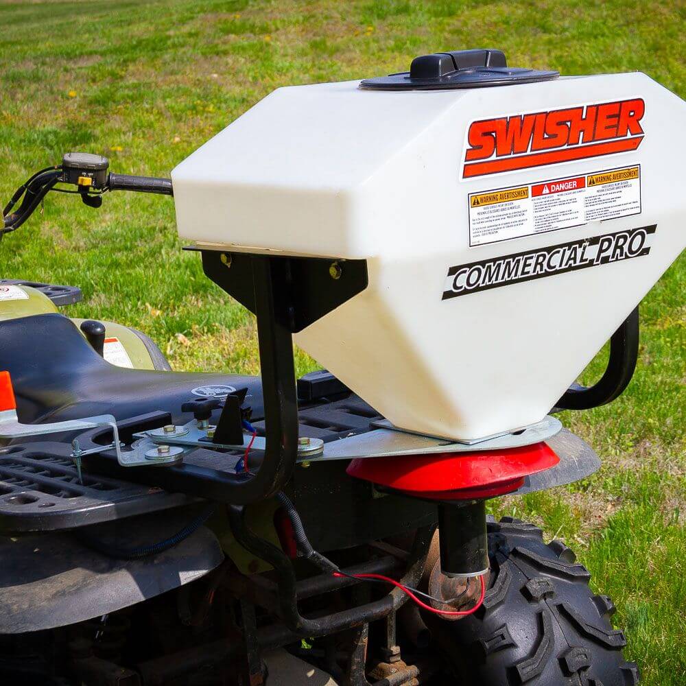 Swisher Commercial Pro ATV Spreader, white, top-down view with mounting bracket and control features.