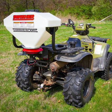 Swisher Commercial Pro ATV Spreader, white hopper on an ATV, rear view with large tires.