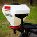 Swisher Commercial Pro ATV Spreader, white with red accents, side view, featuring a hopper and mounting bracket.