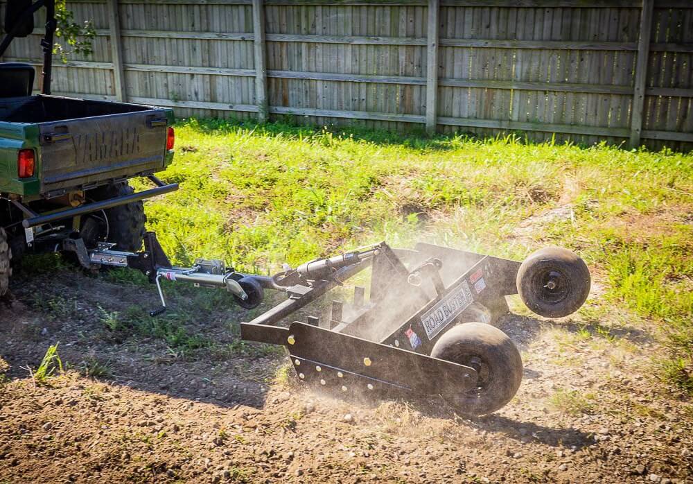 Swisher Commercial Pro RoadBuster Driveway Grader, black with wheels and mounted to an ATV.