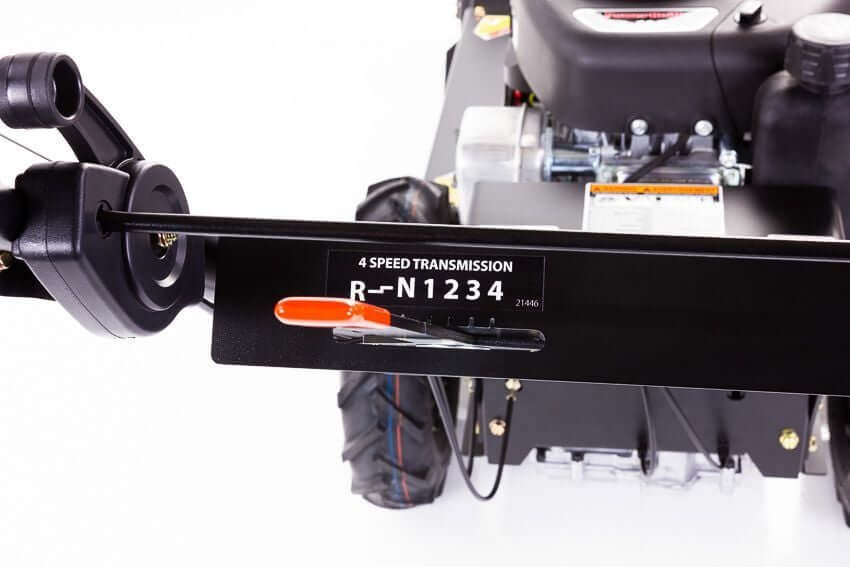 Swisher Predator 24" Walk Behind Rough Cut Mower angled view, featuring controls and robust tires.