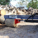 Iron & Oak SMH2419 skid steer log splitter ground-level splitting close-up