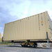 Movex XC-30 all-terrain carrier moving a shipping container